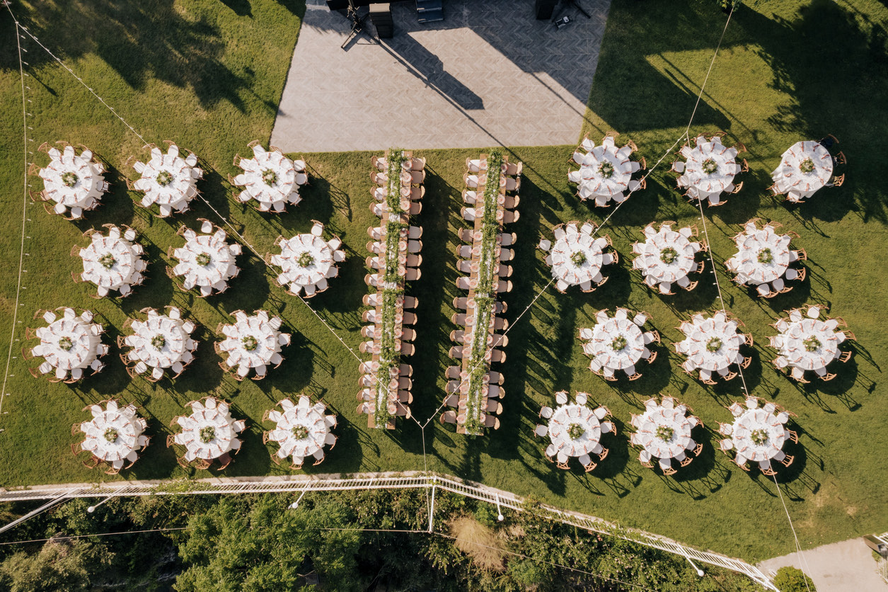Aerial view of a garden wedding with round and long banquet tables