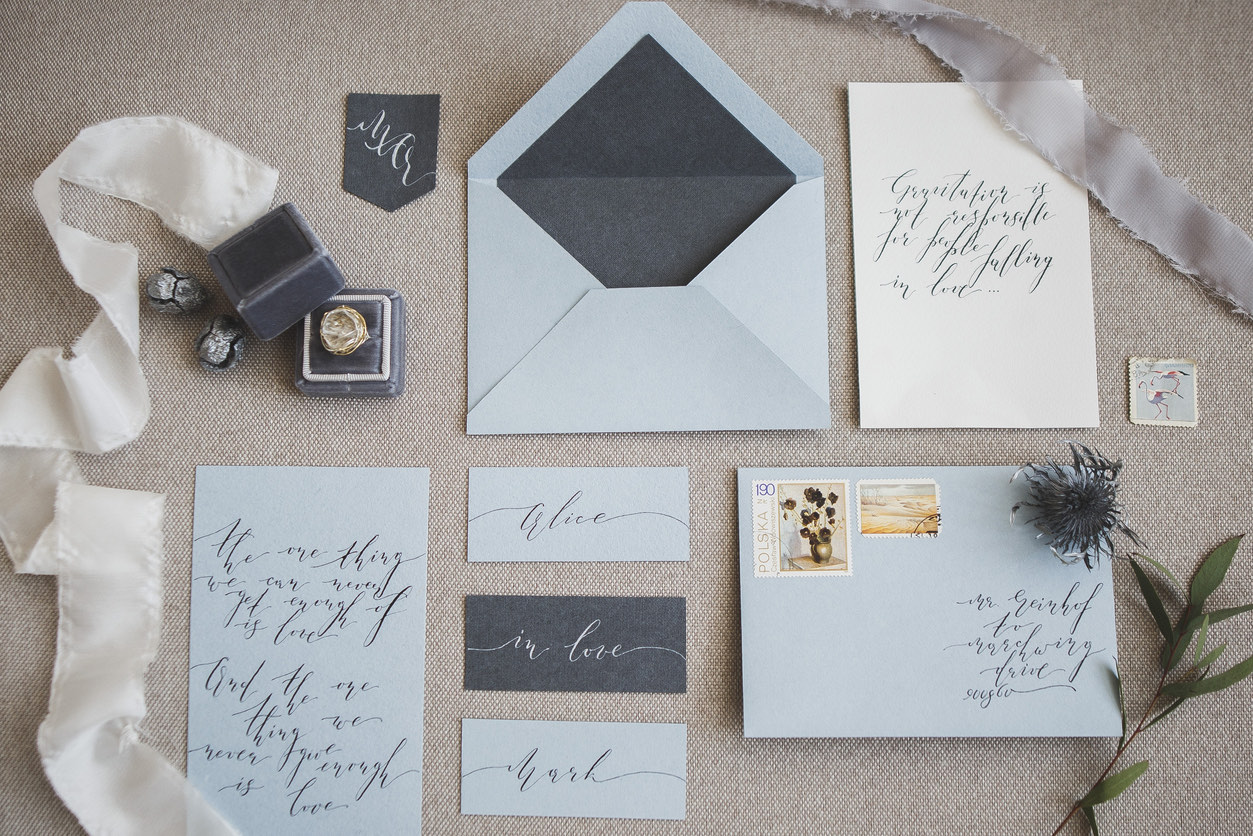 Wedding stationery with hand-lettered calligraphy, envelopes and a ring box