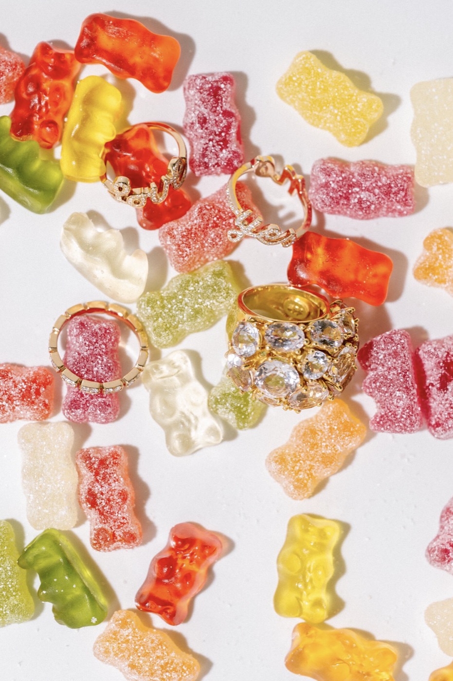 Gold rings with crystals scattered among sugared gummy bears